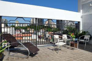a patio with chairs and a table on a balcony at Machado´s Plaza Hotel in Belém