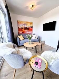a living room with a couch and a tv at Winterberg Appartement 21132 in Winterberg