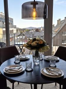 a table with plates and a vase of flowers on it at Winterberg Appartement 21132 in Winterberg