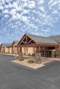 a hotel front of a building with a parking lot at AmericInn by Wyndham Blackduck in Blackduck