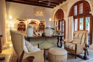 
a living room filled with furniture and a large window at Hotel Casa San Agustin in Cartagena de Indias
