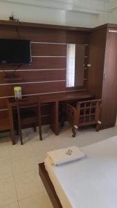 a living room with a desk and a mirror at Shalimar Residency in Cochin