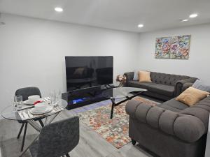 a living room with a couch and a table at Contemporary Two Bedroom Basement Suite in Edmonton