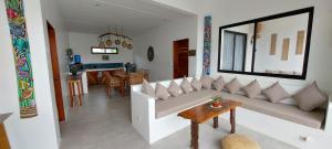a living room with a white couch and a table at Villa Francine El Nido in El Nido