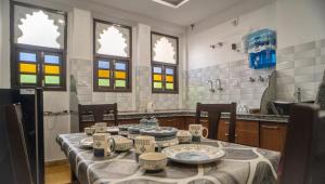a kitchen with a table with dishes on it at Haveli Palace - 2BHK Luxury Apartment in Udaipur
