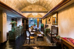 a restaurant with chairs and tables in a room at Katari Hotel at Plaza de Armas in Arequipa