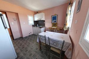 a kitchen with a table and chairs in a room at Papantonis Studios in Chrisopigi