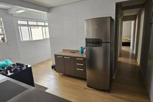 a kitchen with a large stainless steel refrigerator at Vila Caiçara Apê a 40m da Praia in Solemar +34 photos