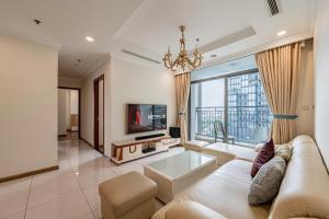 a living room with a couch and a tv at Vinhomes Landmark Luxury Apartment by Navie in Ho Chi Minh City
