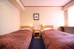 Postel nebo postele na pokoji v ubytování Niigata Station Hotel