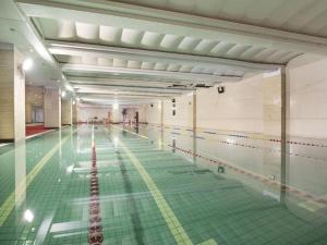 a swimming pool with a green floor and lanes at Beijing Liaoning Hotel in Beijing