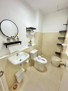 a bathroom with a sink and a toilet and a mirror at Classy Condo in CDO in Cagayan de Oro +30 photos