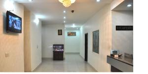 a hallway with a flat screen tv in a building at Hotel Dreamz Residency in Karnāl