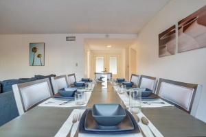 a dining room with a long table with chairs and blue seats at Vintage 6B 3BA Home Pool Hot Tub & Basketball Net in Hillgrove +105 photos