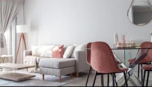 a living room with a couch and a table and chairs at Comfortable lovely apartment in Johannesburg