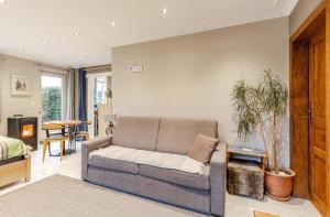 a living room with a couch and a table at Cosy Studio close to Bruxelles South Charleroi Airport in Courcelles