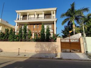 a large house with a fence and a gate at Colonel's Abbey First Floor in Jaipur