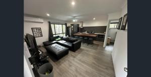 a living room with a couch and a table at Island Haven Wood in Russell Island