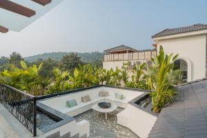 a view from the balcony of a house at ELIVAAS 4 BHK Villa with Pvt Pool & Jacuzzi-Yashgeet in Siolim