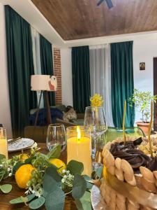 a dining room table with a candle and a table cloth at WoodStar in Ambrolauri