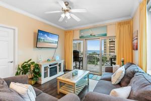 a living room with a couch and a tv at Crystal Tower 409 in Gulf Shores