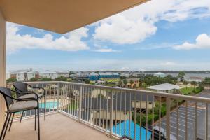 a balcony with chairs and a view of a resort at Crystal Tower 409 in Gulf Shores +30 photos