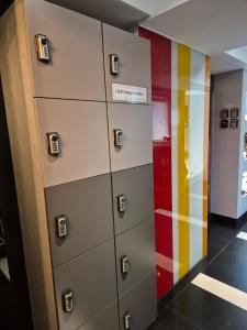 a row of lockers in a room with colorful walls at Let's Stay in Seoul