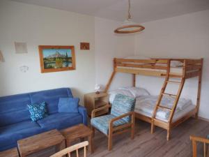ein Wohnzimmer mit einem Sofa und einem Etagenbett in der Unterkunft Good Vintage Apartment in Bad Mitterndorf