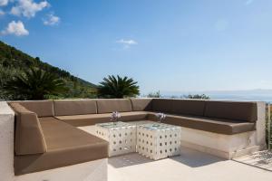 a brown couch sitting on top of a patio at Modern Mediterranean Oasis - Villa ''BOLKA'' in Bol