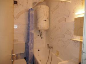 a bathroom with a toilet and a tub and a sink at Good Vintage Apartment in Bad Mitterndorf +51 photos
