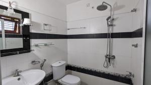 a bathroom with a shower and a toilet and a sink at Hirikatiya Edge in Dickwella