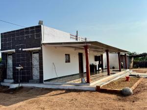 a house under construction with a large porch at Ravrayhomestay in Dholovira