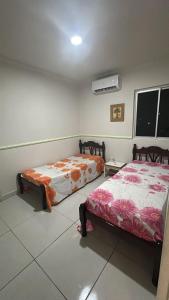 a bedroom with two beds in a room at ACONCHEGANTE Aptº NA PRAIA DE OLINDA in Olinda