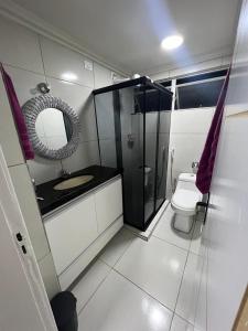 a small bathroom with a toilet and a mirror at ACONCHEGANTE Aptº NA PRAIA DE OLINDA in Olinda