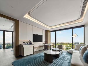 a living room with a couch and a table at Hilton Shanghai Hongqiao International Airport in Shanghai