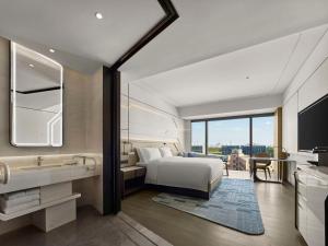 a hotel room with a bed and a bathroom at Hilton Shanghai Hongqiao International Airport in Shanghai