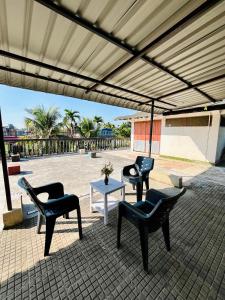 a group of chairs and a table under a roof at Heritage Inn Homestay in Sibsāgar