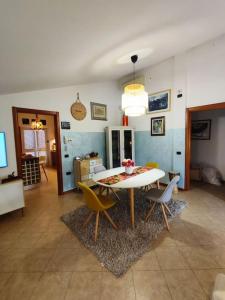 a living room with a white table and chairs at Appartamento Hygge House in Montecatini Terme