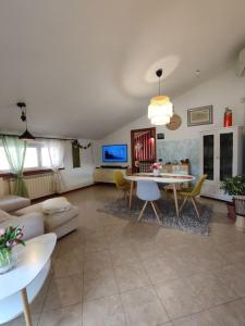 a living room with a couch and a table at Appartamento Hygge House in Montecatini Terme