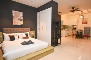 a bedroom with a large white bed with a black wall at Twin Galaxy Suite by Nest Home in Johor Bahru +56 photos