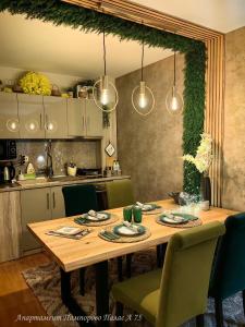 a kitchen with a wooden table with chairs and lights at Apartment Pamporovo Palaсe A75 in Pamporovo +55 photos