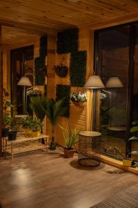 a room with plants on the side of a building at Wooden Villa Sormoni in Tskaltubo