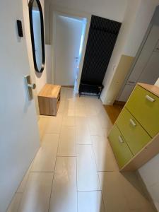 an empty hallway with a door and a mirror at Floridsdorfer Apartment - Free Highspeed-Internet in Vienna