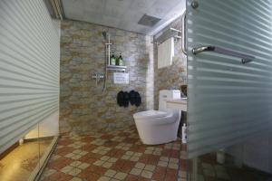 a bathroom with a toilet and a sink at LQJ Riverside Guest House in Fenghuang County +53 photos
