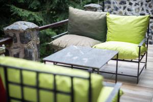a couch and a coffee table on a deck at Holiday Cottage Pedja in Kopaonik