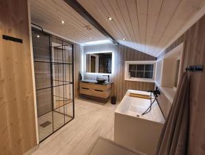 a large bathroom with a shower and a sink at Hytte-23 Cozy cabin close to Kvitfjell in Fåvang
