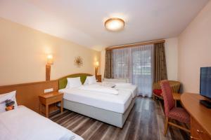 Posteľ alebo postele v izbe v ubytovaní Bliem's Familienhotel