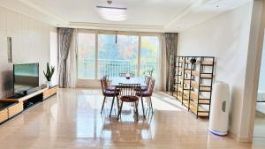 a dining room with a table and chairs and a television at st ar house in Goyang