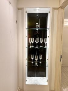 a wine glass cabinet with several wine glasses at st ar house in Goyang