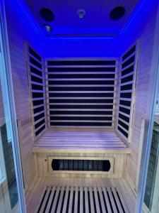 a sauna with a blue lighting in a room at Oaza Mira LAZE in Nova Gradiška +80 photos